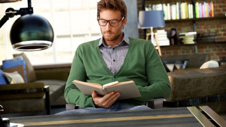 44831027 - young man reading book at old-fashioned home.