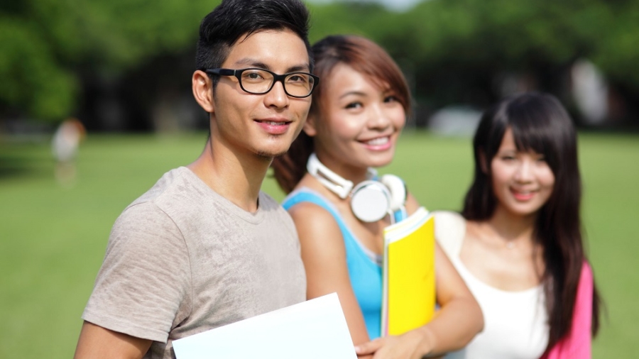 Happy College students smile to you on campus, asian